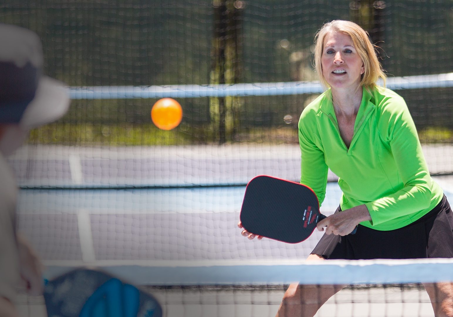 Players on a pickleball court, focused and ready to compete